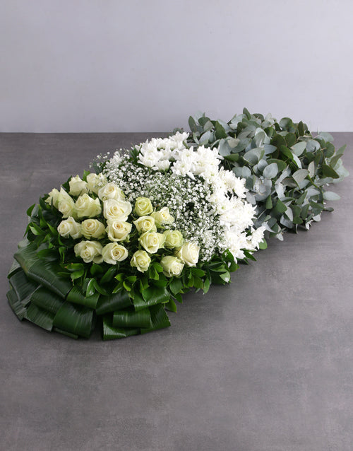 Green and White Funeral Coffin Display