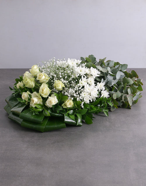 Green and White Funeral Coffin Display